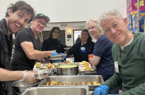 Cheerful volunteers making tacos